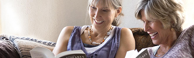 Two women reading books together